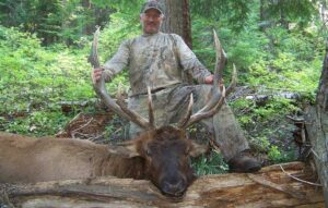 Smiling hunter and his elk trophy